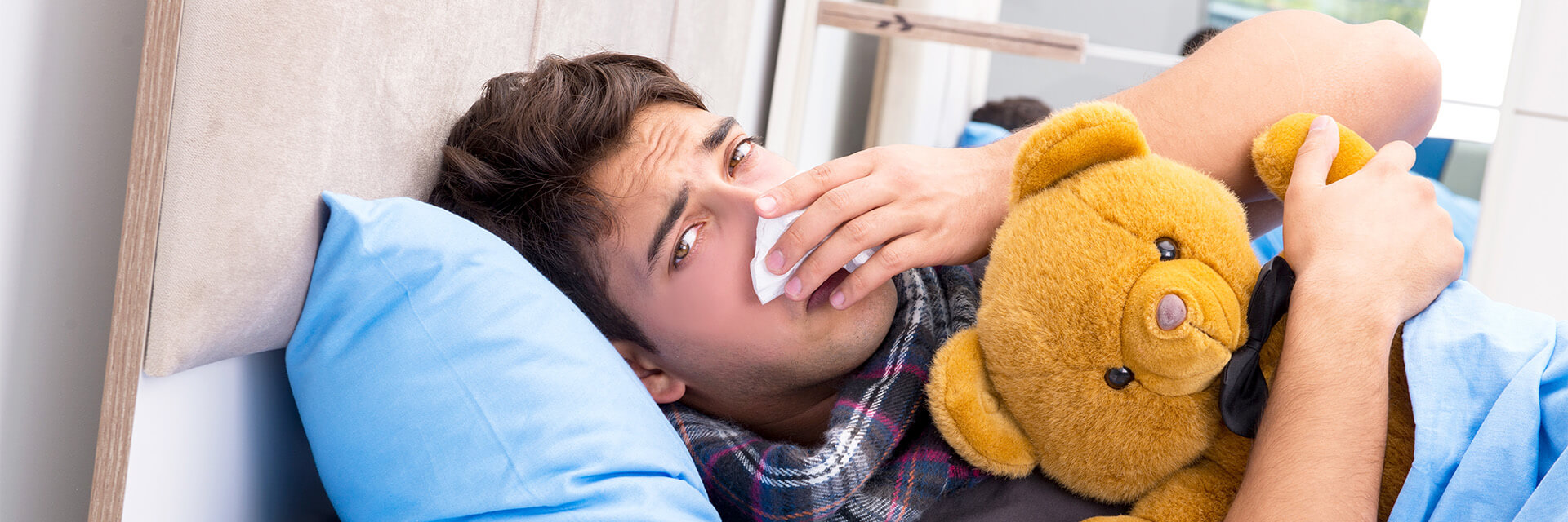 Header-man-in-bed-holding-teddy-bear.jpeg