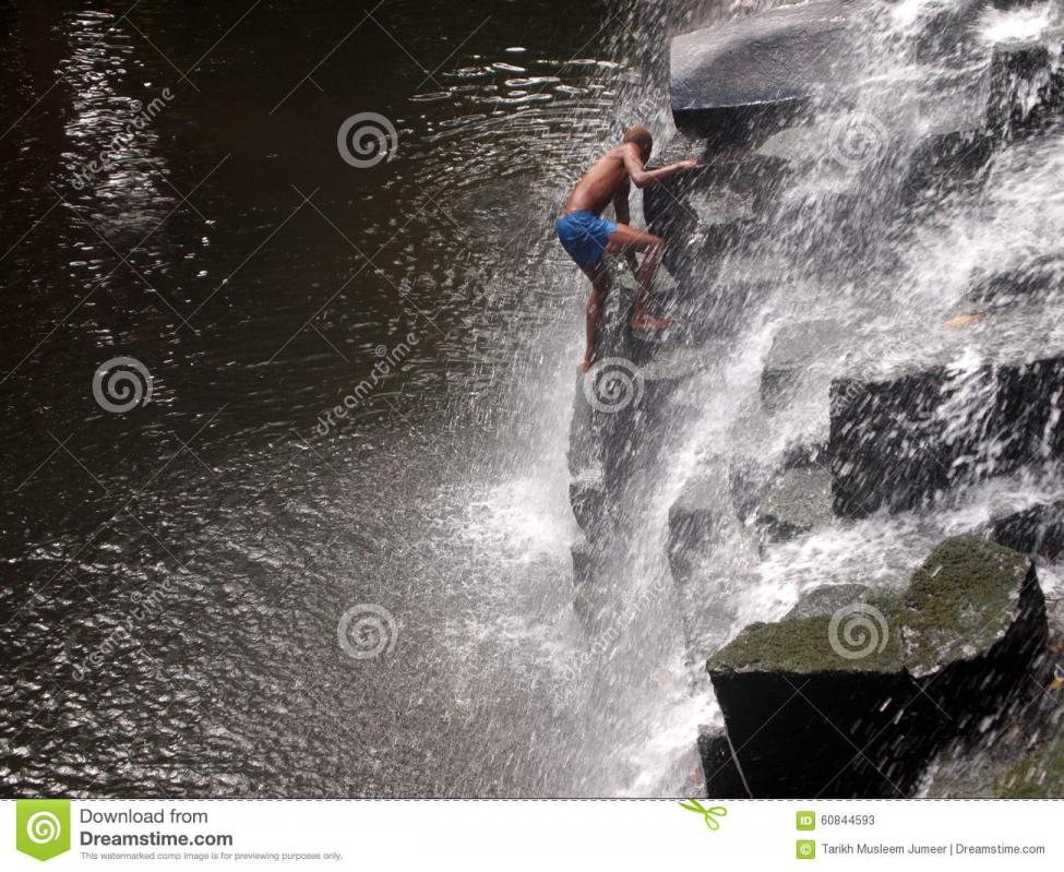 man-climbing-waterfalls-rocks-amidst-water-flowinf-top-waterfall-rochester-falls-mauritius-60844.jpg