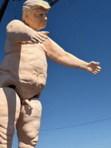 Crooked-and-Obscene-Trump-GIant-Naked-Marionette-sideways-view_1727574791.png