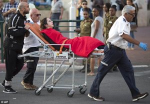 2E0AED8000000578-3299893-Israeli_rescue_personal_evacuate_a_woman_from_a_stabbing_attack_-m-3_14.jpg