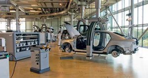 vw_transparent_factory_interior_production_wide_view_w_parts_bins_cars_workers_panorama_400_p605.jpg