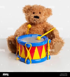 teddy-bear-with-plastic-toy-drum-PFRF9M.jpg